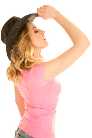 a cowgirl in her western hat looking up, with her eyes closed.の写真素材