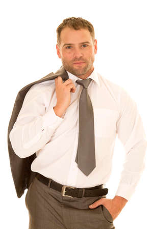 a man in his suit and tie holding on to his jacket over his shoulder.の写真素材