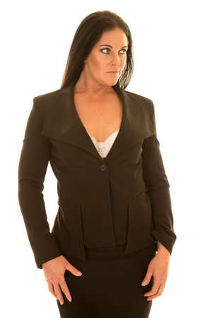 A woman standing in her business suit looking to the side.の写真素材