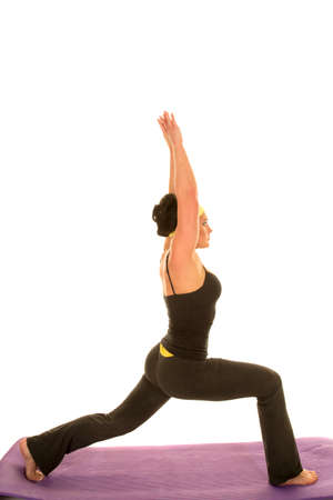 A woman stretching her body out doing a yoga stretch.の写真素材
