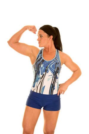 a woman in her fitness clothing flexing her arms.の写真素材