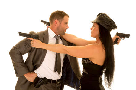 A couple looking at each other, with their weapons pointed over each others shoulders.