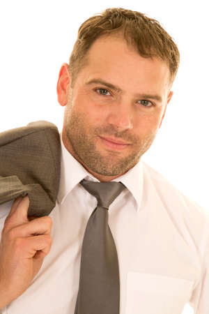 a man in his business clothing with his jacket over his shoulder.の写真素材