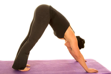 A woman stretching out her body doing a yoga stretch.の写真素材