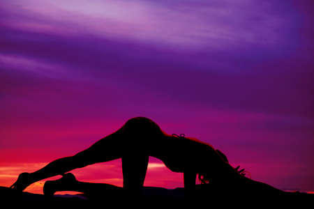 A silhouette of a woman crawling in her bikini.の写真素材