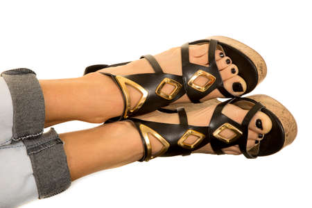 a close up of woman's legs in her jeand, with her shoes on.
