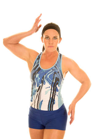 a woman in her fitness clothing flexing her arms and posing.の写真素材