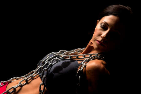 A woman in sports attire highlighted with a chain around her neck.の写真素材