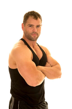 A man in his fitness tank with his arms folded .の写真素材