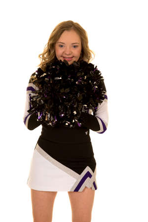 A teen cheerleader with a big smile , she has down syndrome.