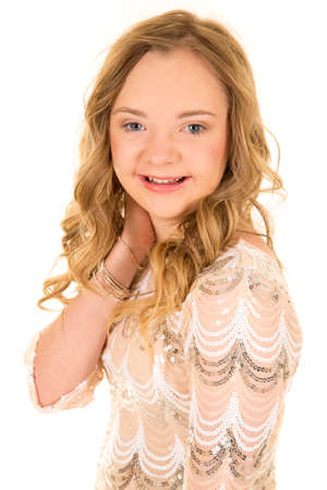 a woman with down syndrome with a big smile, with her hand on her neck.の写真素材
