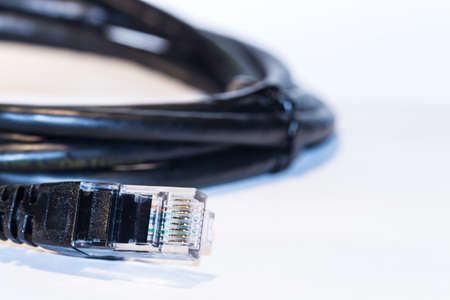 The black internet cable on white backgroundの写真素材