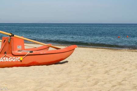 Red lifeboat on the beautiful sicilian beachの写真素材
