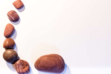 Sea pebbles on a white background.の写真素材