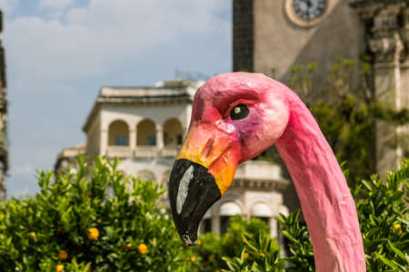 Pink heron paper mache in a Sicilian squareの写真素材