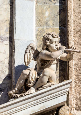 the statue of a cherub with a fluteの写真素材