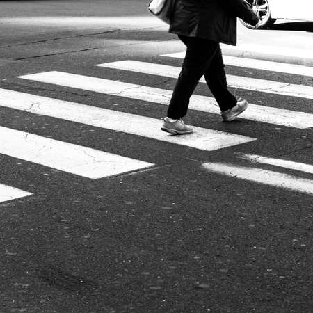 Men walking on zebra crossing street.の写真素材