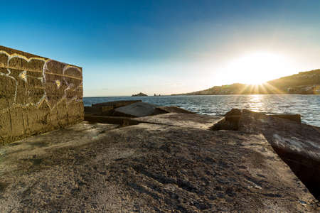 The sunset from a small Sicilian port in autumn timeの写真素材