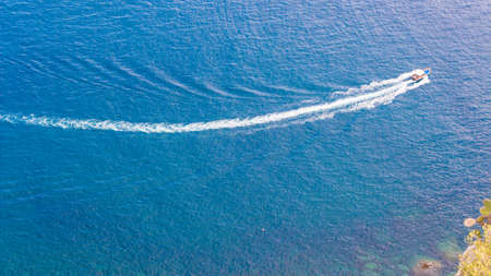 Speedboat cruising over the blue Mediterranean Seaの写真素材
