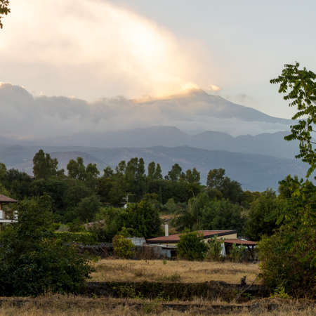 View of volcano Etna from a small Sicilian village at sunsetの写真素材