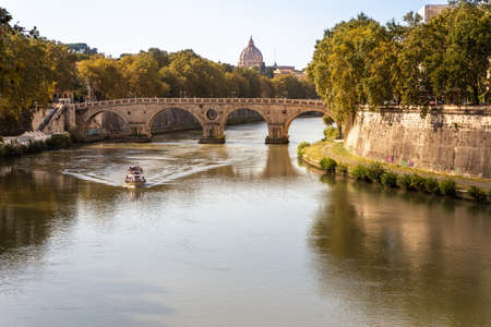 Glimpse of the river Tiber crossed by a boatの写真素材