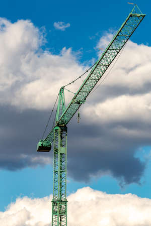 A crane is a type of machine, generally equipped with a lifting rope, wire ropes or chains and pulleys, which can be used both to lift and lower the materials and to move them horizontally.の写真素材