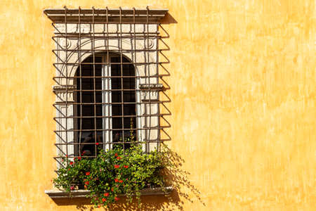windows in the facades of ancient medieval housesの写真素材