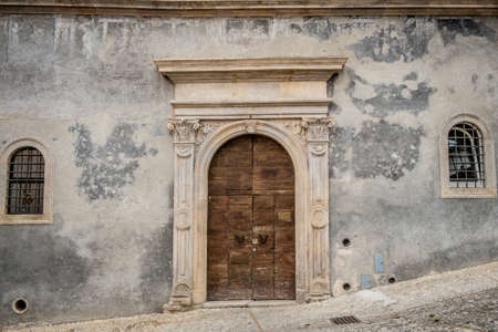 Italy: Old door on medieval stone wallの写真素材