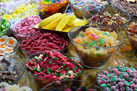 Multi-colored oriental spices, dried fruit and ginger on the counter of the oriental marketの写真素材