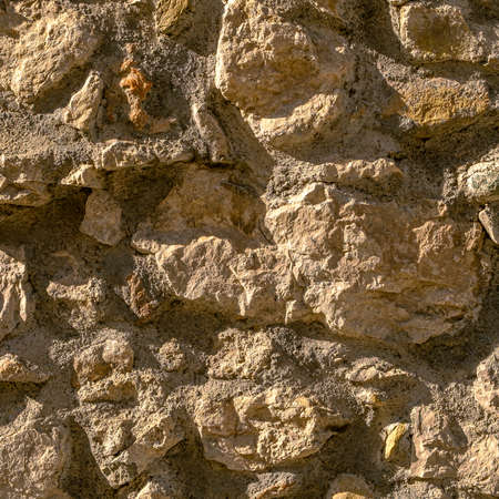 Orange jagged wall background and texture with vignetting and blank copyspace for text or advertising.の写真素材