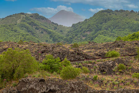 the road that climbs up the Etna volcanoの写真素材