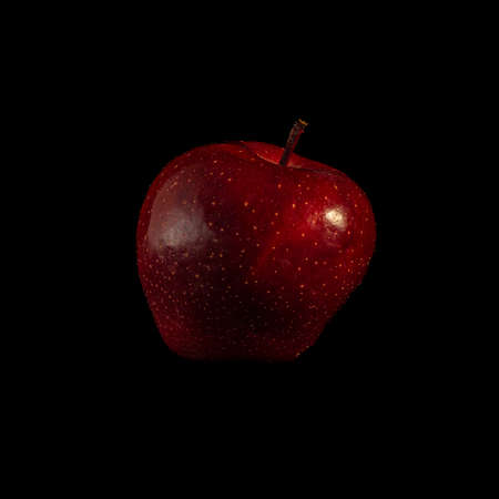 a red apple on a black background, ideal for wallpapersの写真素材