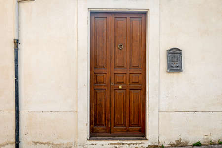 Brown door with golden knocker of a typical Sicilian houseの写真素材