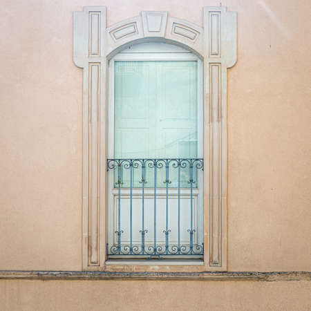 windows in the facades of ancient baroque housesの写真素材