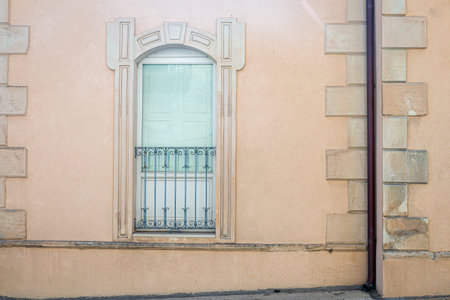windows in the facades of ancient baroque housesの写真素材