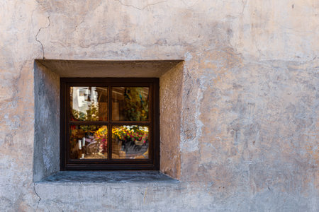 The ancient window on stone wall, for backgroundの写真素材