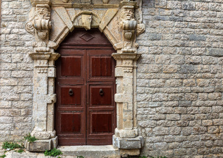 Sicily: Old door on medieval stone wallの写真素材