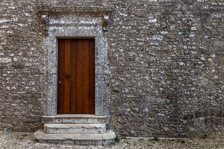 Sicily: Old door on medieval stone wallの写真素材