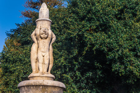 Carved stone statue with green backgroundの写真素材