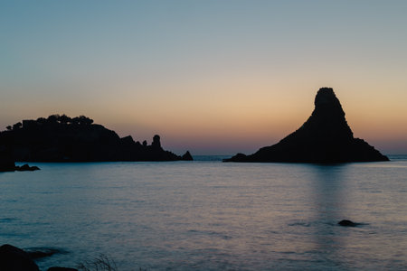 Rock formations at sunset seaの写真素材