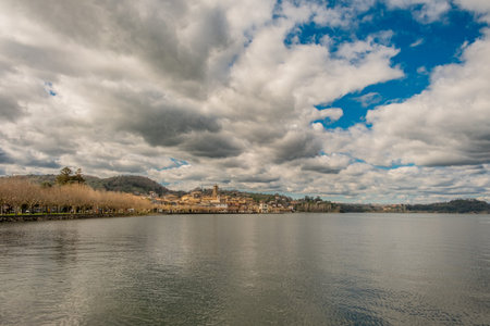 Charming lakeside town under dramatic cloudy skyの写真素材