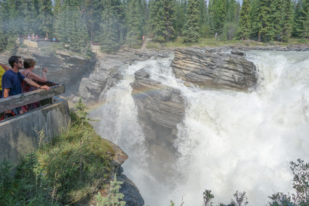 JASPER, CANADA - AUGUST 14, 2014: Tourists visiting the Athabasca Falls in Jasper National Park in Alberta Canadaのeditorial素材