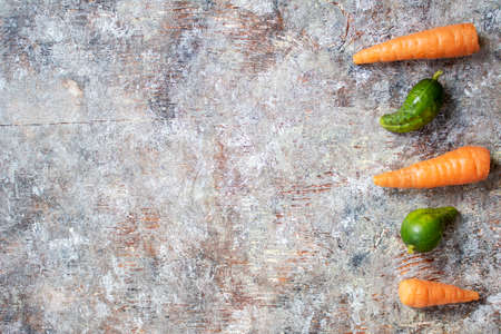 Flat lay of vegetables on a white wood backgroundの写真素材