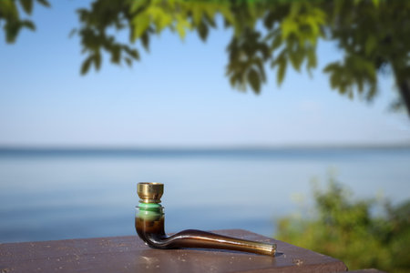 Cannabis pipe on a picnic table at a campground.の写真素材