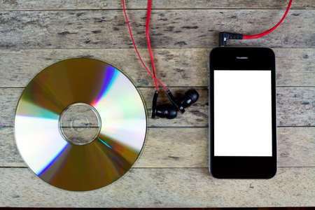 smartphone, cd disc, headphone on wood tableの写真素材