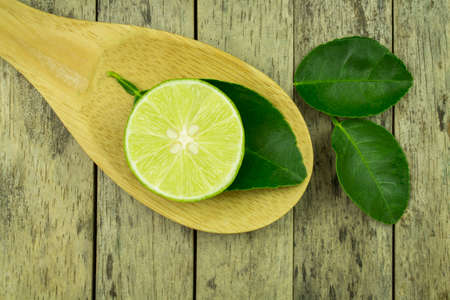 lime slice and leaf on wood padleの写真素材
