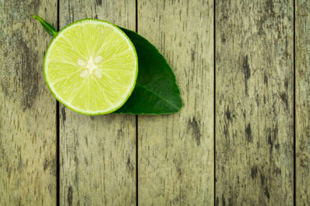lime slice and leaf on wood plank backgroundの写真素材