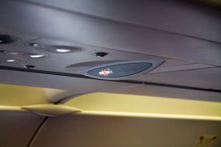 no smoking sign overhead on the airplane