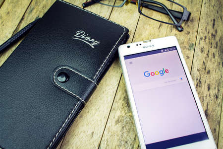 BUNG KAN, THAILAND - OCTOBER 09, 2015: notebook, glasses, pen, smart phone with google search on...