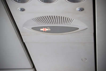 no smoking sign overhead on the airplaneの写真素材